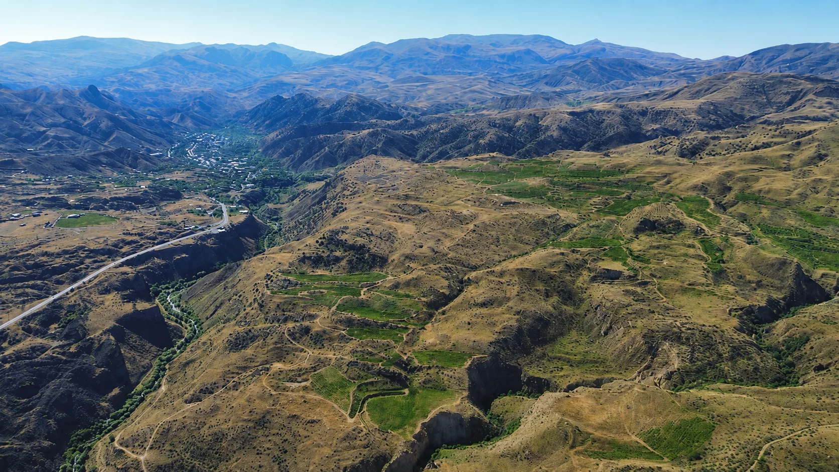 Aerial view over the Arpa Valley estate lands, the village below, and surrounding mountains